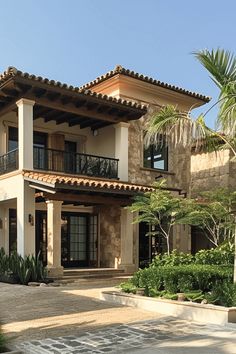 a large house with two balconies on the second floor