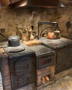 an old fashioned stove with pots and pans on it