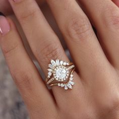 a woman's hand with two rings on top of her finger and one ring in the middle