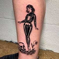 a woman with a skeleton tattoo on her leg