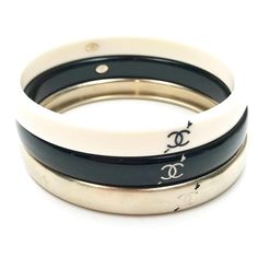 Chanel Gold Ivory Black Love Arrow CC Bracelet Bangle *Marked 10 *Made in Italy *Comes with original box -Approximately 2.75″ wide, approximately 7.9″ inner circum. -One size fits most -3 bangles can be worn as a set or individually -Hairline scratches 1160-10244  Please see the measurements section for best approximate dimensions. Designer White Bangle Bracelets, Designer White Bangle Bracelet, Designer White Bracelets For Wedding, Designer Adjustable White Bracelets, Luxury White Stackable Bracelets, Love Arrow, Bracelet Bangle, Black Love, Bangle Bracelets