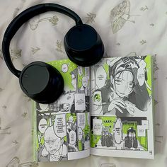 an open book with headphones on top of it