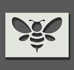 a black and white image of a bee on a gray background with the shadow of it's wings