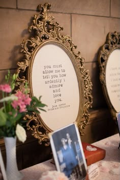 there are two framed pictures on the table with flowers in vases and photos next to them