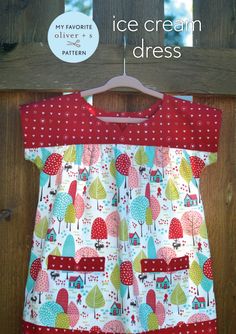 a red and white dress hanging on a wooden door with the words ice cream dress written below it