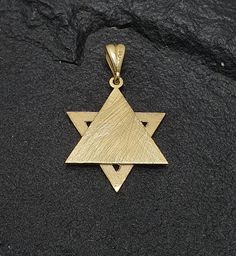 Star of David pendant, with the Western Wall, engraved on the back layer,14K yellow gold. The Star of David is an important Jewish symbol. Sizes: Height: 20 mm Width: 18 mm IMPORTANT: Import duties may apply Notice: Please provide your phone number in the notes section of your order for shipping. Jewish Symbol, Pomegranate Jewelry, Jewish Symbols, Judaica Jewelry, Gold Hamsa, Hamsa Pendant, Star Of David Pendant, Jewish Jewelry, Western Wall