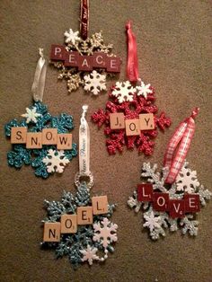 christmas ornaments made from scrabbles on the floor with words that spell out peace and joy