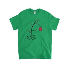 Charlie Brown Christmas Tree Kids T-Shirt Printed on a regular fit 100% Cotton Gildan T-Shirt. Heather Grey & Purple are 90% Cotton/10% Polyester More Info Behind Charlie Brown Christmas Tree Kids T-Shirt T-Shirts & Apparel - Charlie Brown Christmas Tree Kids T-Shirt Christmas Gift Short Sleeve T-shirt, Graphic Tee T-shirt As Gift In Green, Christmas Cotton T-shirt With Screen Print, Christmas Graphic Tee With Short Sleeves, Christmas Graphic Print Short Sleeve T-shirt, Green Short Sleeve Shirt For Gift, Green Cotton T-shirt For Holiday, Green Christmas Crew Neck T-shirt, Green Christmas T-shirt For Holiday