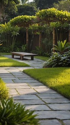 a stone path leads to a wooden bench in the middle of a lush green garden