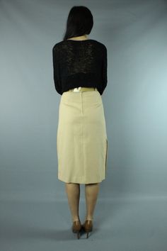 Vintage 80's high waisted skirt. Fitted, pencil styling. Buttons on the side seam of the skirt. Matching belt. Back zipper with buttons at the waist. Model is 5 ft. 7 in. and wears a size small in tops and a size 5 in bottoms. Condition: Excellent, unworn condition. Had tags on it, but I removed them for a photo shoot and misplaced them. Brand: T R Bentley Fabric: 50% Polyester, 50% Rayon Measurements: Taken flat, then doubled when necessary. Size tag: vintage size 5/6, probably fits an x-small Retro Fitted Midi Skirt, Retro Fitted Pencil Skirt For Spring, Retro High Waist Skirt For Work, Spring Retro Fitted Pencil Skirt, Retro Workwear Lined Skirt, Retro Fitted Lined Pencil Skirt, Retro Fitted Skirt With Belt Loops, Vintage Fitted Midi Skirt, Workwear Pencil Skirt With Belt Loops