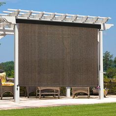 an outdoor area with chairs and a pergolated screen on the side of it