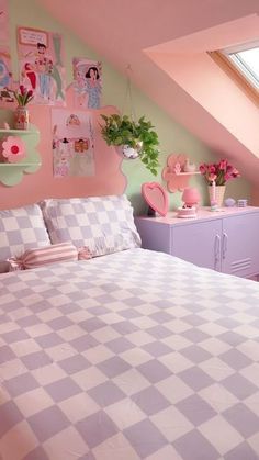 a bedroom with pink and green decor on the walls, checkered bedspread