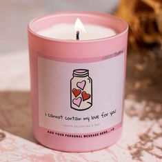 a pink candle with two hearts in a jar that says i cannot't contain my love for you