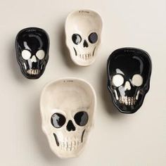 three black and white skull bowls sitting next to each other