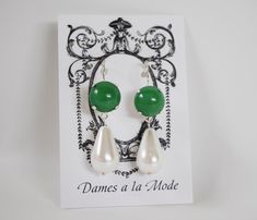 Glass stones in a soft, subtle shade of Jade green! I've paired them with white Glass pearls for a classic combination.These earrings measure about an inch and a half (3.8 cm), including the hook. Available in all finishes. Silver Plate shown here. The Hook, Jade Green, Green Glass, White Glass, Antique Gold, Silver Plate, Silver Earrings, Jade, Pearl Earrings