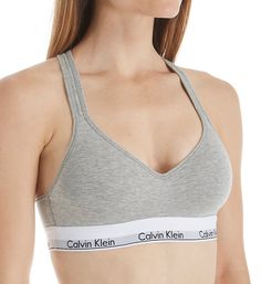 Highly sought after, highly comfortable bra with instantly recognizable Calvin Klein logos and push-up padding for a flattering lift. Made of cotton, modal, polyester and elastane. Wireless, contour/t-shirt cup has a medium graduated push-up bump ridge along bottom and side for enhanced cleavage. Cotton-blend cup overlay has a soft, smooth finish. Flattering neckline with a tall center front. Exposed elastic Calvin Klein underband secures fit and lends light support. Sides and back are self-line Calvin Klein Seamless Sports Bra With Medium Support, Calvin Klein Medium Support Seamless Sports Bra, Calvin Klein Stretch Seamless Sports Bra, Fitted Seamless Calvin Klein Bra, Calvin Klein Fitted Seamless Bra, Calvin Klein Seamless Fitted Bra, Calvin Klein Seamless Bra, Cotton Workout Bra, Calvin Klein Medium Support Sports Bra For Workout