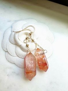 These gorgeous boho style natural red quartz crystal point earrings are a great gift for yourself or someone you love.  Genuine red crystal quartz points dangle from your choice of 14k gold fill or sterling silver earring wire. Each crystal is natural and one of a kind so there will be some variations in color and inclusions. These elegant, simple and minimalist dangly drop earrings will make a perfect gift for dressy or casual occasions and are great for bridesmaids, best friend, anniversary, s Best Friend Anniversary, Crystal Quartz Earrings, Friend Anniversary, Boho Earring, Red Quartz, Earring Wire, Earring Gift, Earrings Dainty, Wedding Jewelry Earrings