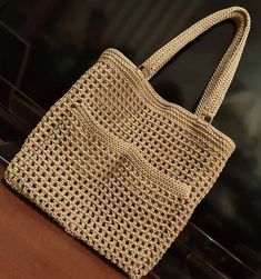 a white purse sitting on top of a wooden table