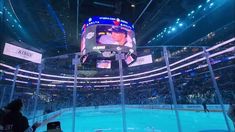 an ice hockey arena with people watching the game