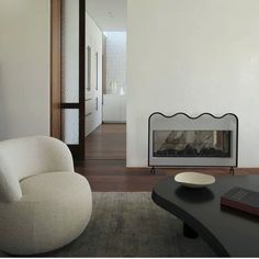 a living room with a fireplace and white walls