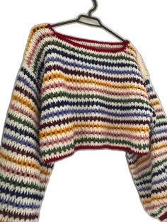 a multicolored sweater hanging on a hanger