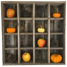 an old wooden box filled with lots of different types of pumpkins and pine cones