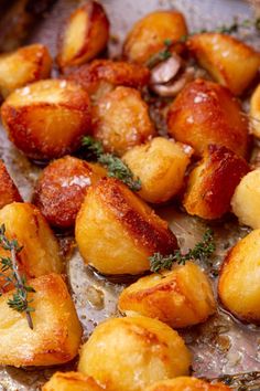 cooked potatoes with herbs and seasoning in a pan