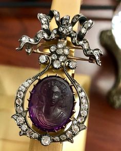 Pieces like these transcend being a piece of jewelry alone; this is history. Made some time between the early 1700's and the early 1800's, this brooch has been hand made in silver and 18K yellow gold. It is centered by a partially faceted and carved, high-relief amethyst cameo and surrounded by numerous old mine and rose cut diamonds. There is a pin closure as well as a hook on the back so that it can be hung as a pendant which is original to the piece. A stunning piece of antiquity that is not 1920s Jewelry, Bow Jewelry, Jewelry Boards, High Relief, Diamond Brooch