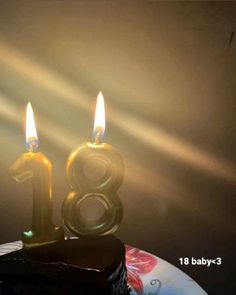 a birthday cake with two candles in the shape of the number eight on it,