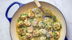 a pan filled with meatballs covered in gravy and parmesan cheese