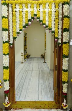 an entrance decorated with yellow and white flowers