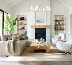 a living room filled with furniture and a fire place in front of a large window