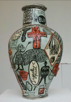 a large vase with many different designs on it's body and sides, in front of a white background