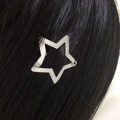 a woman's hair with a star shaped clip on it