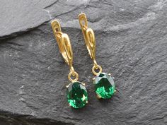 Gold Emerald Earrings set with a Created Emerald in a flawless diamond cut & clarity, deep green color, at 10x8mm each (6 Ct a pair).Gold Vermeil: 18k Gold over Solid 925 Sterling Silver ☞ made to last. Click here for ☞ Matching RingClick here for ☞ Matching Pendant Details:• Created Emerald in a flawless clarity and deep green color• Emerald: 10x8mm each, 6 Ct a pair, diamond cut• Lever Back Closure - "English Lock"• Dimensions: Height 30mm, Width 8mm• 18k Gold VermeilSKU 2829 Green Teardrop Earrings With Prong Setting, Classic Green Diamond Cut Earrings, Elegant Green Diamond Cut Earrings, Emerald Earrings With Diamond Cut For Gift, Emerald Diamond Cut Earrings Gift, Emerald Oval Earrings For May Birthstone, Oval Emerald Earrings For May Birthstone, Formal Green Diamond Cut Earrings, Oval Emerald Earrings With Prong Setting