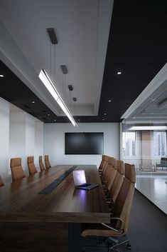 an empty conference room with chairs and a flat screen tv