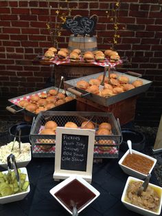 a table topped with lots of food next to a brick wall