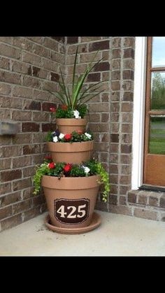 three tiered planter with flowers on the front porch