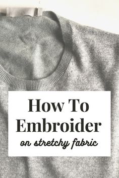 a gray sweater with the words how to embroider on it in black and white