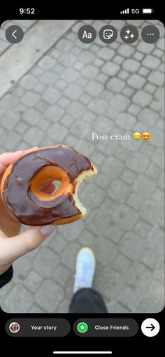 a person holding a half eaten donut in their hand