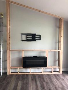 a tv is sitting on top of a wooden shelf