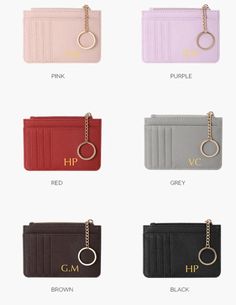 four different colored purses with gold hardware on each card holder and two key chains hanging from the front