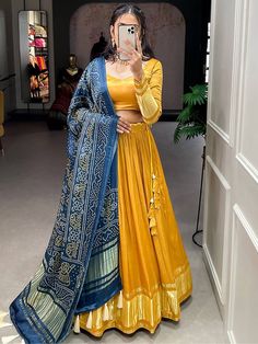 Be the epitome of beauty and grace in every occasion and event with the Capricious Yellow Gaji Silk Haldi Wear Lehenga Choli with Dupatta available at Ethnic Plus. This stunning ensemble is made of high-quality plain gaji silk material that features a beautiful yellow color and is highlighted by exquisite dyeing lagdi patti detailing.
This beautiful yellow lehenga is stitched up to 42 inches with a 3.40-meter flair and has cancan and micro cotton inner material. Meanwhile, the yellow plain gaji Chaniya Choli Designs, Bandhani Dupatta, Simple Lehenga, Yellow Lehenga, Indian Wedding Outfit, Lehenga Designs Simple, Choli Designs, Indian Dresses Traditional, Traditional Indian Outfits