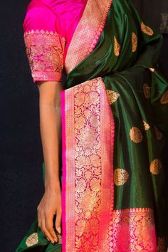 This gorgeous saree is made of high-quality Katan Banarasi silk, flaunting a stunning green hue with exquisite golden floral motifs and a beautiful pink border. Indulge in luxury and elegances with this timeless classic. Transitional Green Dola Silk Traditional Wear, Unstitched Green Traditional Wear With Border, Traditional Dark Green Dupatta With Cutdana, Dark Green Traditional Wear With Cutdana, Green Banarasi Silk Blouse Piece, Green Meenakari Dola Silk Blouse Piece, Green Art Silk Blouse Piece With Traditional Patterns, Green Traditional Katan Silk Blouse Piece, Traditional Green Katan Silk Blouse Piece