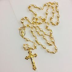 This is a jewelry quality Catholic rosary. Features: Beautiful 8mm Swarovski cream glass pearls. 2" Gold Plated Two-Tone Pewter Crucifix. 1" Gold Plated Two-Tone Pewter Center Piece. Gold base metal bead caps and chain. Packaged in a gold foil gift box. Not finding the rosary you would like? Custom, made to order rosaries are available. I have access to an endless choice of beads, Crucifixes and center pieces. I specialize in special occasion pieces perfect for First Communion, Confirmation, Wed Elegant Pearl Beaded Rosary, Elegant Pearl White Pearl Rosary, Elegant Pearl Rosary With Round Beads, Elegant Pearl Rosary With 8mm Beads, Pearl Rosary With 8mm Beads, Gold Rosary, Pearl Rosary, Catholic Wedding, Catholic Jewelry