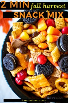 a bowl full of halloween snack mix with the words 2 min fall harvest snack mix