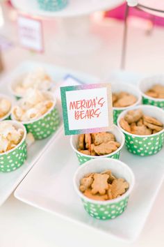 cupcakes and snacks are on display in green polka dot paper cups, with a sign that reads mermaid bears