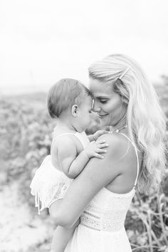 a woman holding a baby in her arms