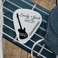 a guitar pick with a wedding date on it