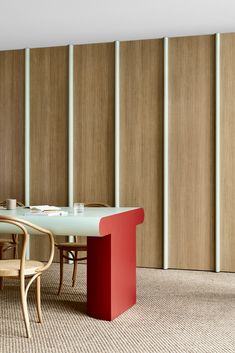 a dining room table and chairs in front of wooden partitions